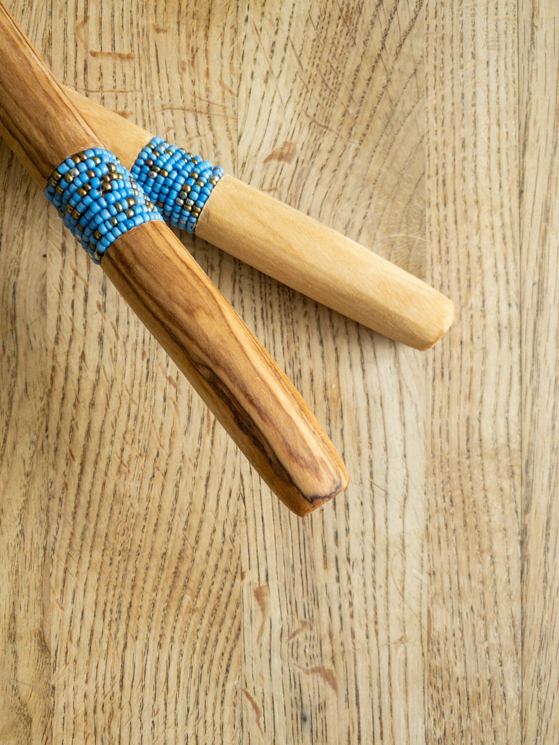 blue and gold beaded wooden salad server handles