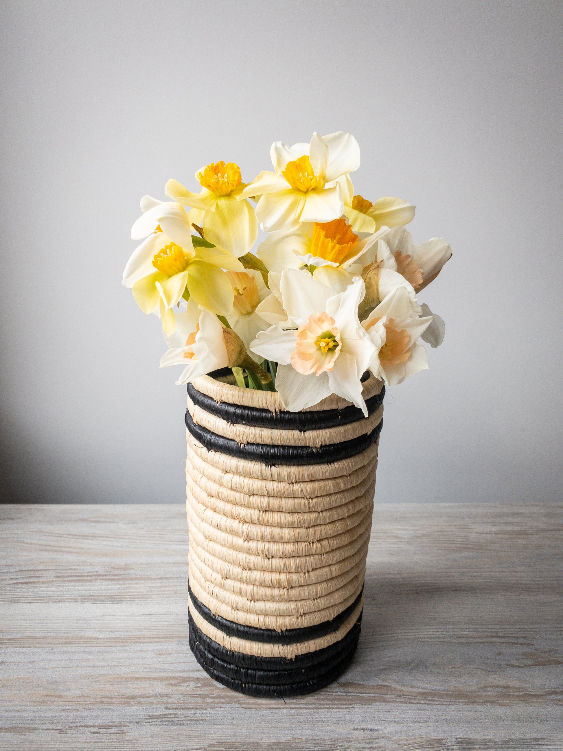 easter daffodils in a unique black and white vase