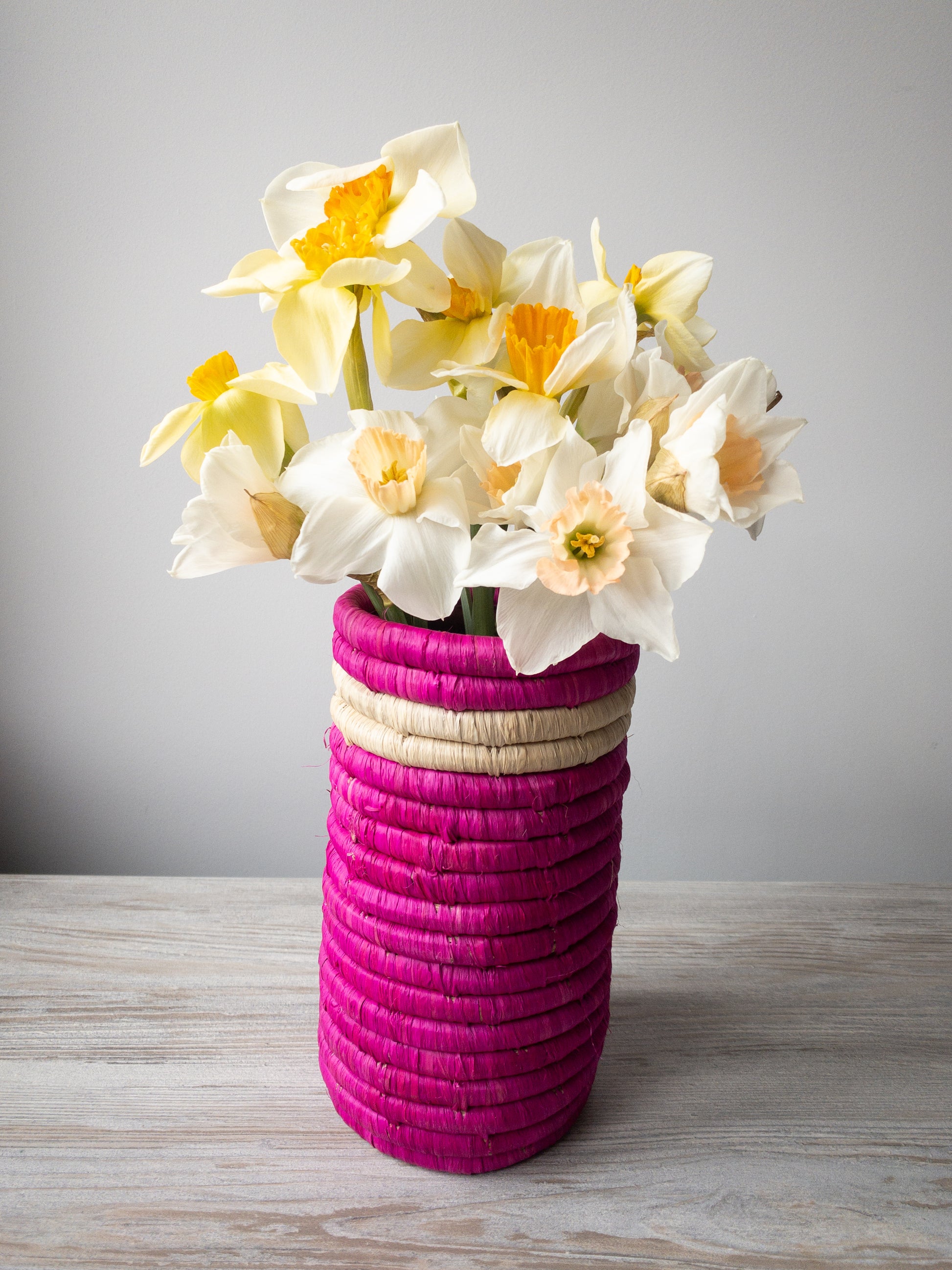 ethically made pink vase with daffodils