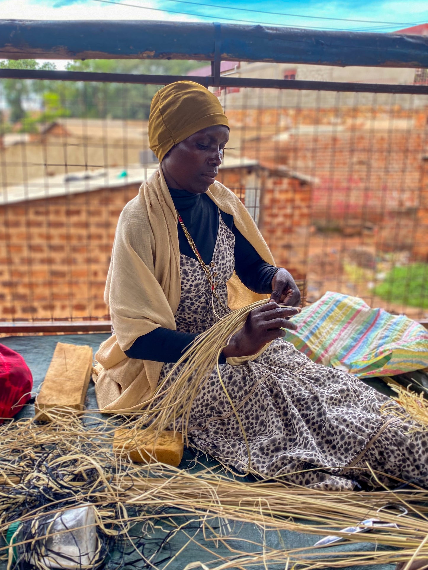 ugandan lady weaving basket traditional methods